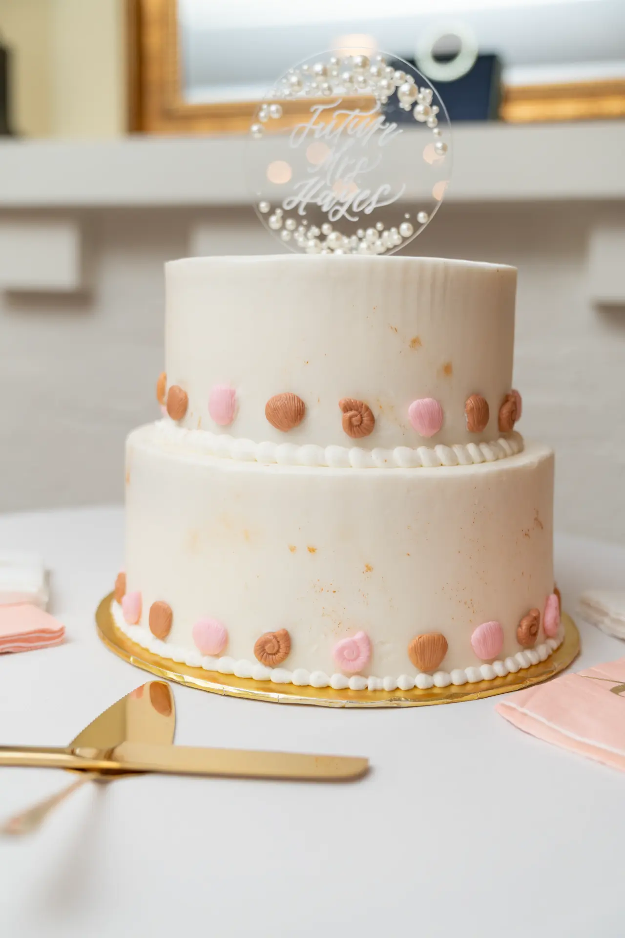 Tiered white celebration cake topped with a sparkler
