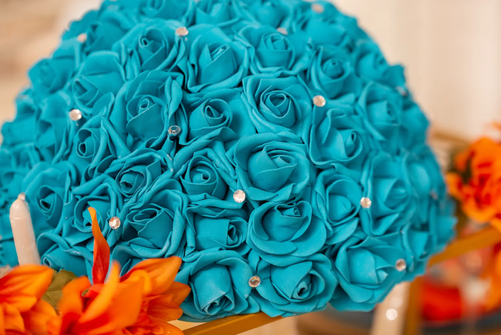 Bouquet of teal roses with orange accents