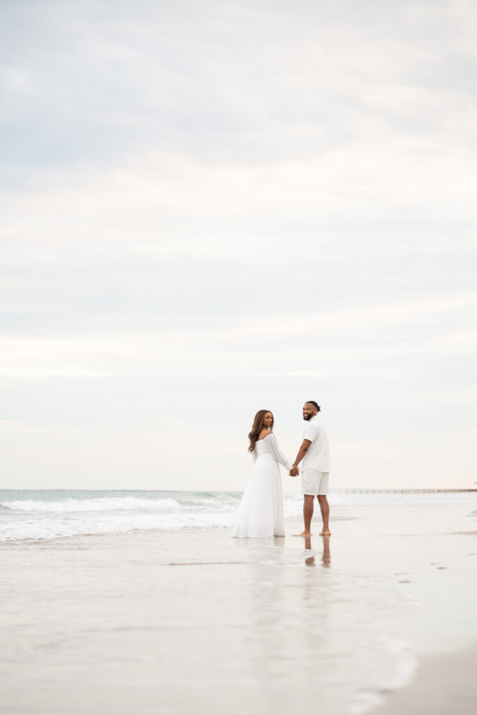 Couple holding hands on a misty beach