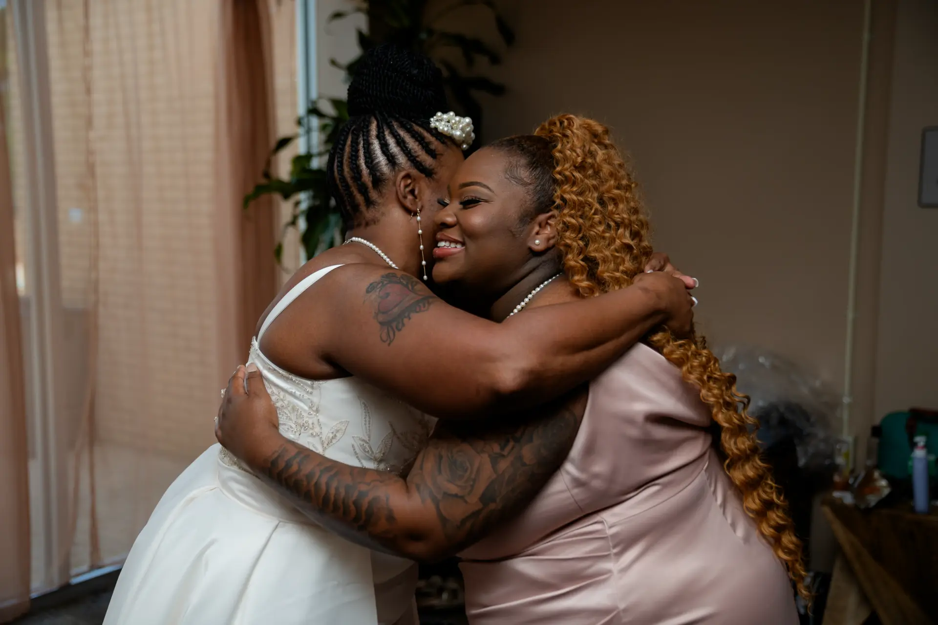 Bride hugs a family member before the ceremony