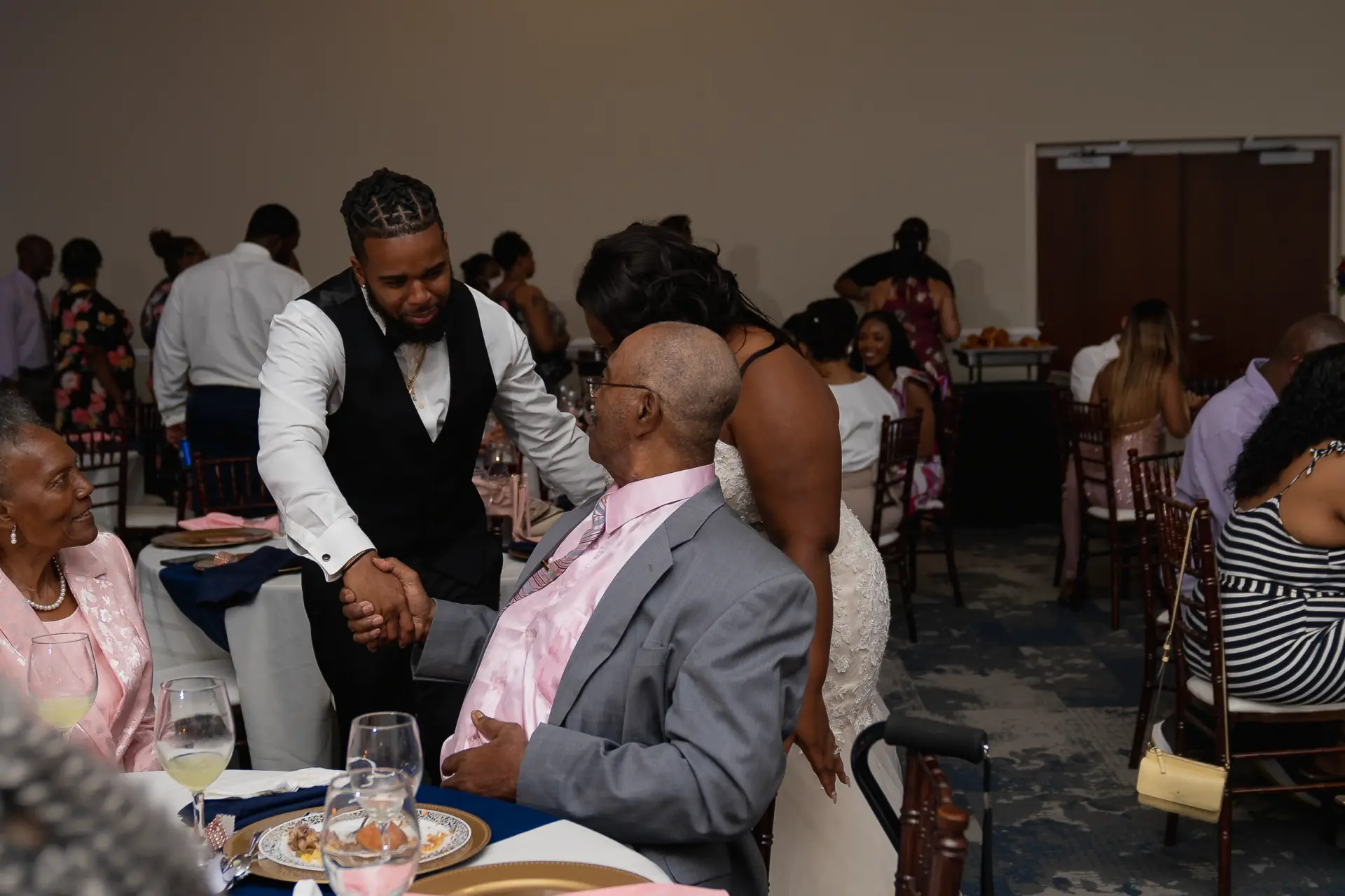 Guests seated and smiling at the reception