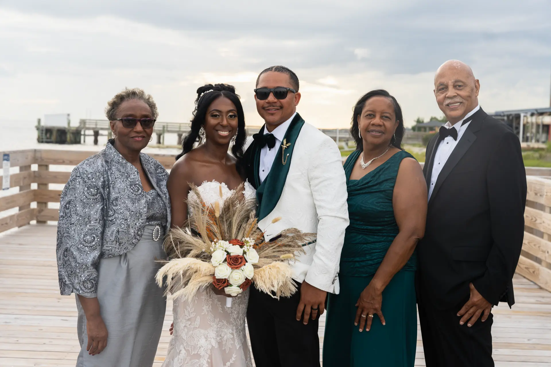 Bride with her family on a waterfront deck after the ceremony
