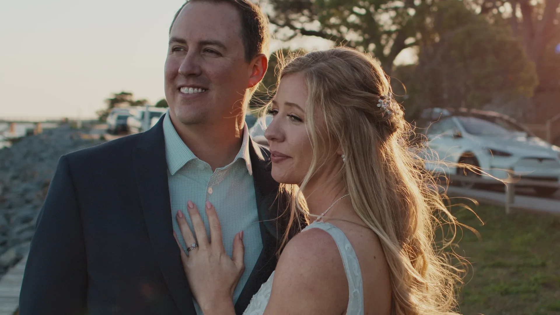 Newlyweds standing together in warm evening light